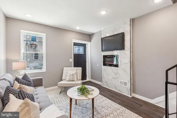 a living room with furniture and a flat screen tv