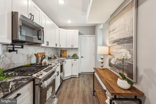 a kitchen with a stove a sink and a microwave