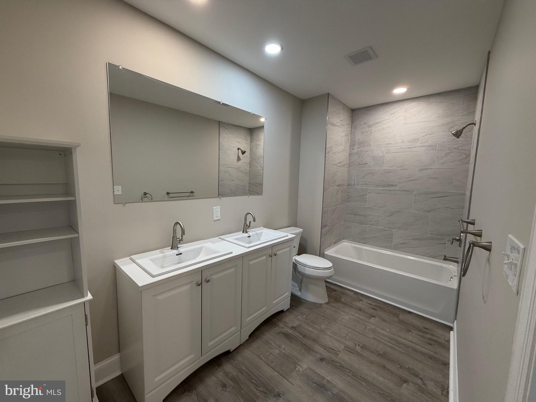 380 West Weymouth Road Vineland, NJ 08360 - Photo 6 of 10 a bathroom with a tub sink toilet and a mirror