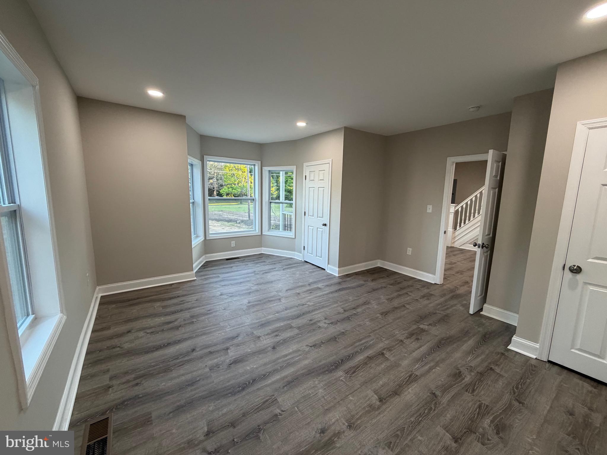 380 West Weymouth Road Vineland, NJ 08360 - Photo 7 of 10 an empty room with wooden floor and windows