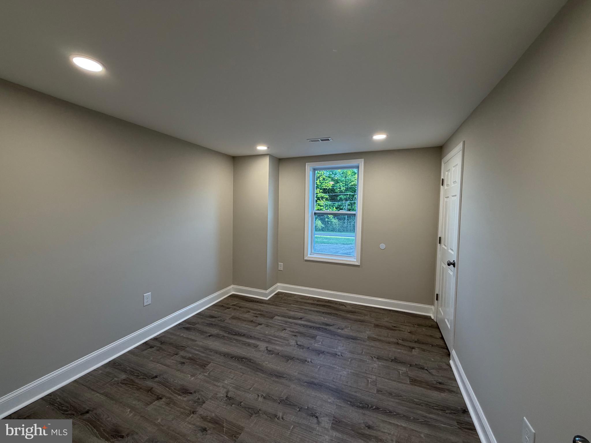380 West Weymouth Road Vineland, NJ 08360 - Photo 8 of 10 an empty room with wooden floor and windows
