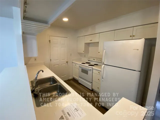 a white refrigerator freezer sitting inside of a kitchen