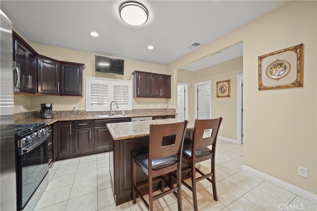 895 North Los Robles Avenue Pasadena, CA 91104 - Photo 13 of 58 a kitchen with granite countertop a sink cabinets and stainless steel appliances