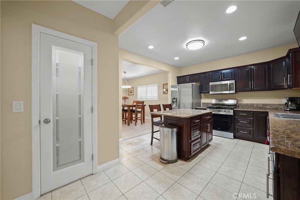 895 North Los Robles Avenue Pasadena, CA 91104 - Photo 14 of 58 a kitchen with stainless steel appliances granite countertop a stove top oven a sink and a refrigerator
