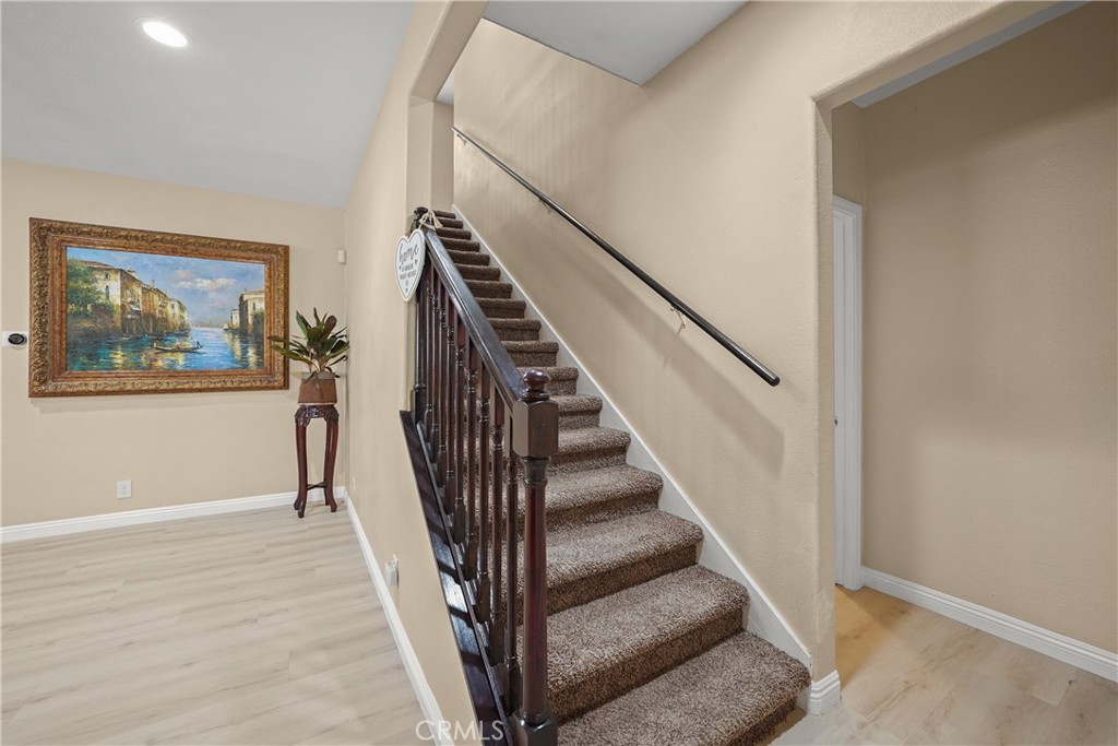 895 North Los Robles Avenue Pasadena, CA 91104 - Photo 17 of 58 a view of staircase with wooden floor and a rug