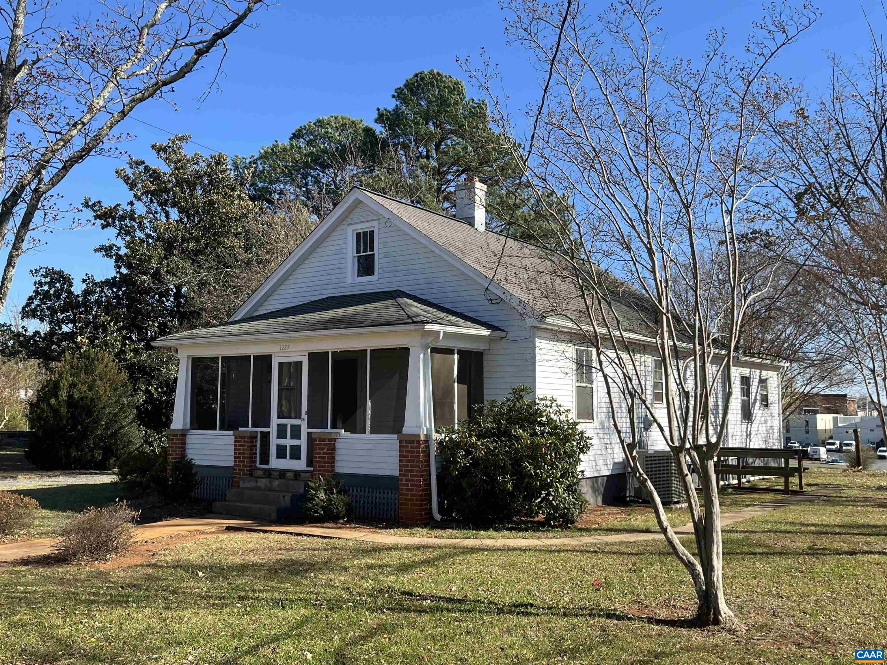 1227 Blue Ridge Avenue Crozet, VA 22932 - Photo 16 of 17 a view of a white house with large windows and a small yard