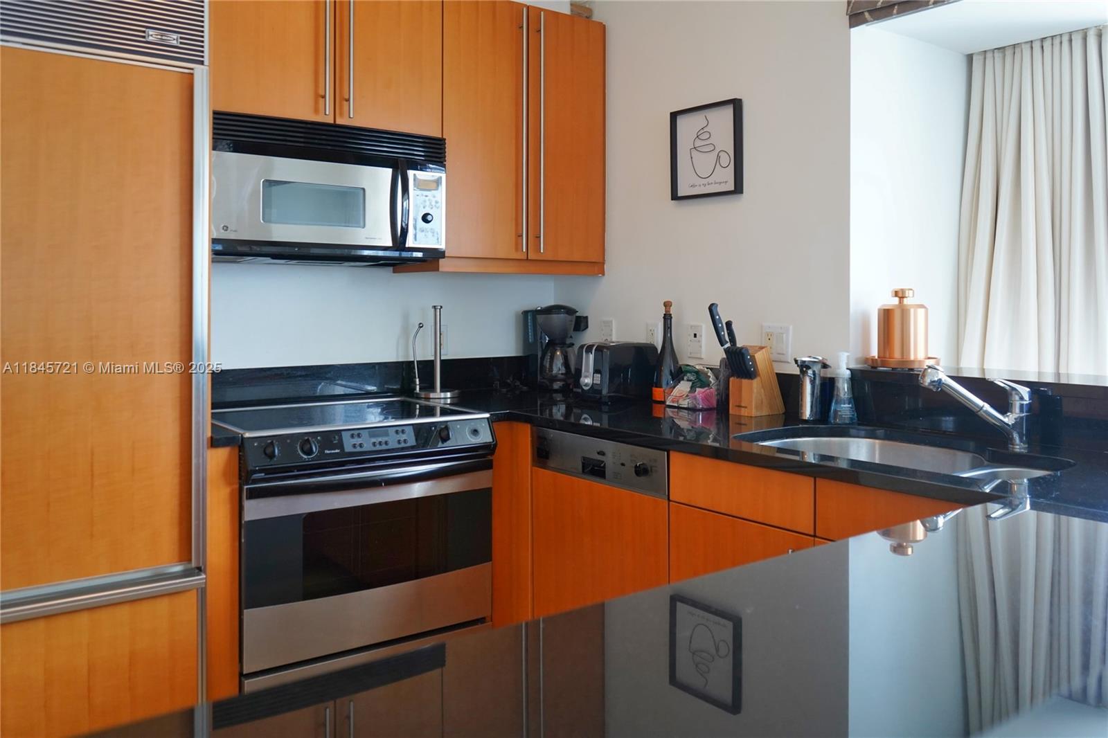 1435 Brickell Avenue, Unit 3412 Miami, FL 33131 - Photo 1 of 44 a kitchen with stainless steel appliances granite countertop a stove microwave and sink