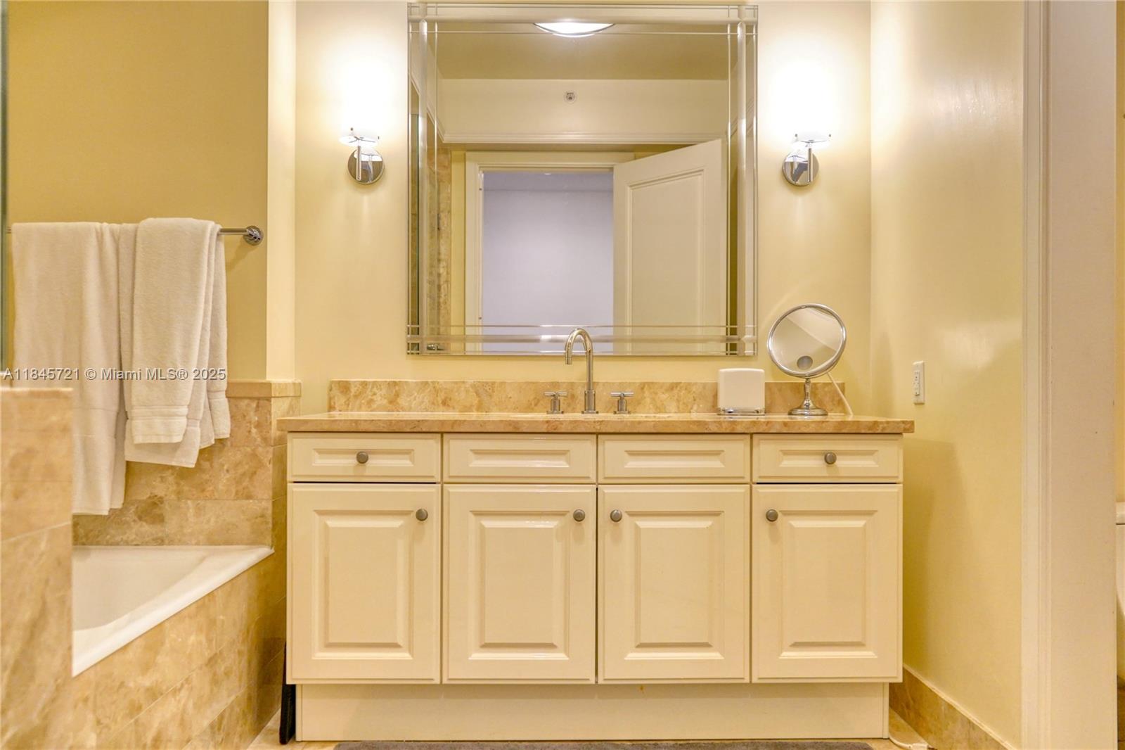 1435 Brickell Avenue, Unit 3412 Miami, FL 33131 - Photo 12 of 44 a bathroom with a sink and a mirror