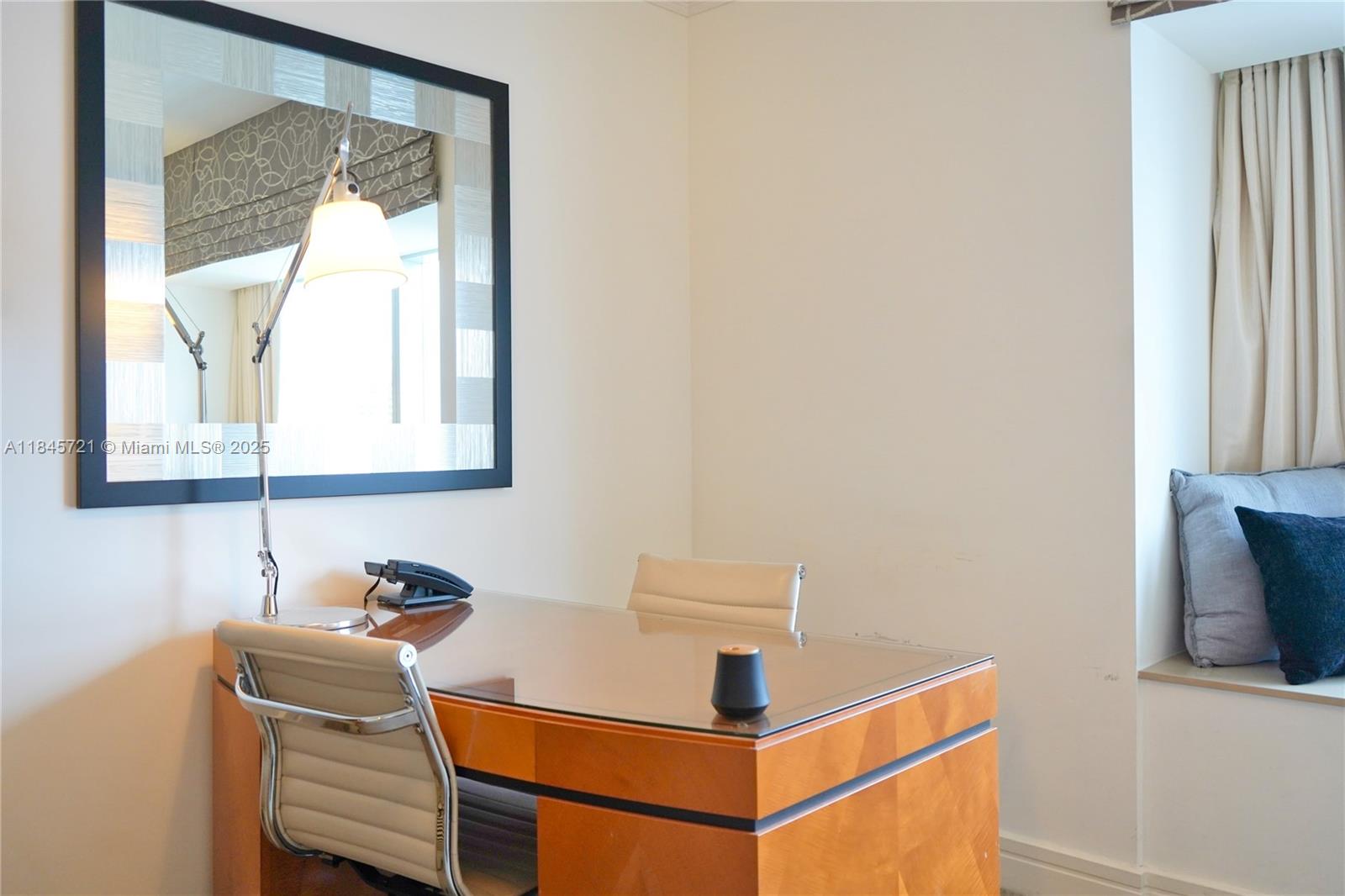 1435 Brickell Avenue, Unit 3412 Miami, FL 33131 - Photo 15 of 44 a room with a table and a chair