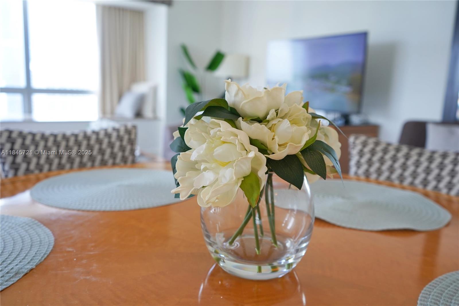 1435 Brickell Avenue, Unit 3412 Miami, FL 33131 - Photo 18 of 44 a vase of flowers sitting on a table