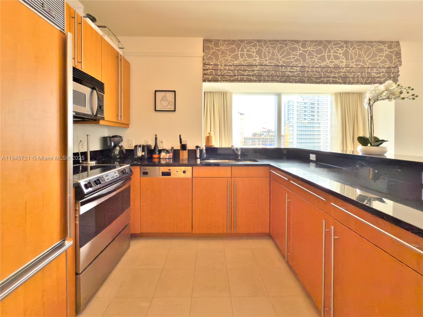 1435 Brickell Avenue, Unit 3412 Miami, FL 33131 - Photo 2 of 44 a kitchen with stainless steel appliances granite countertop a sink and a stove