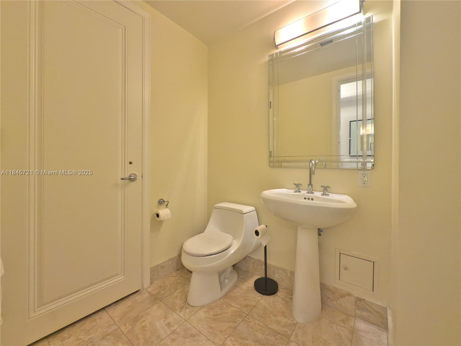 1435 Brickell Avenue, Unit 3412 Miami, FL 33131 - Photo 21 of 44 a bathroom with a sink toilet and a mirror