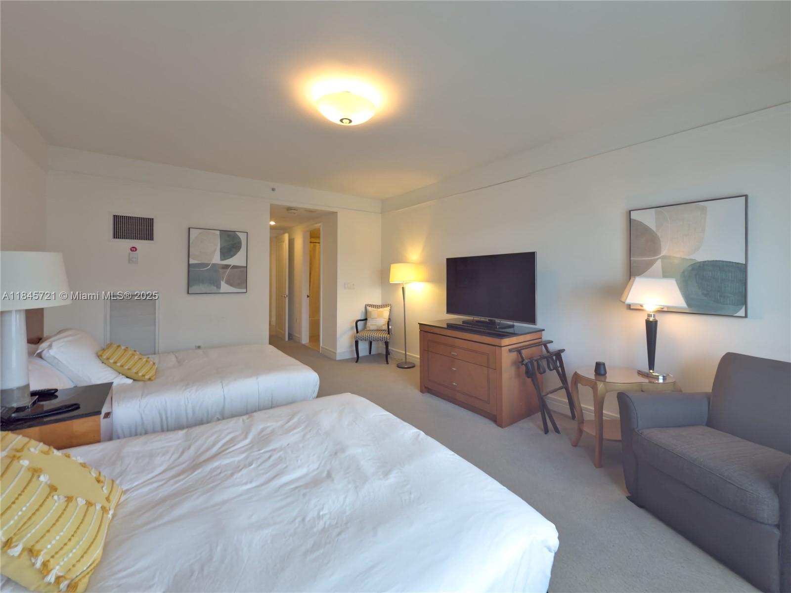 1435 Brickell Avenue, Unit 3412 Miami, FL 33131 - Photo 23 of 44 a living room with furniture and a flat screen tv