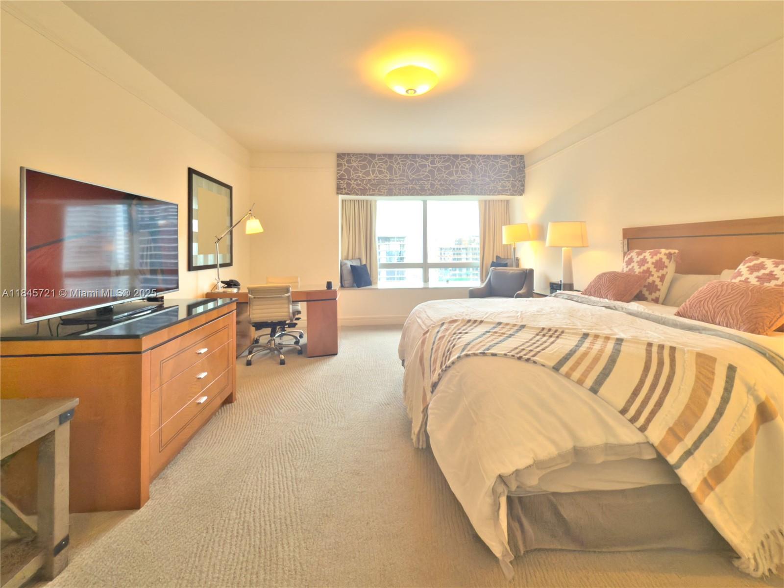 1435 Brickell Avenue, Unit 3412 Miami, FL 33131 - Photo 25 of 44 a spacious bedroom with a large bed and flat screen tv