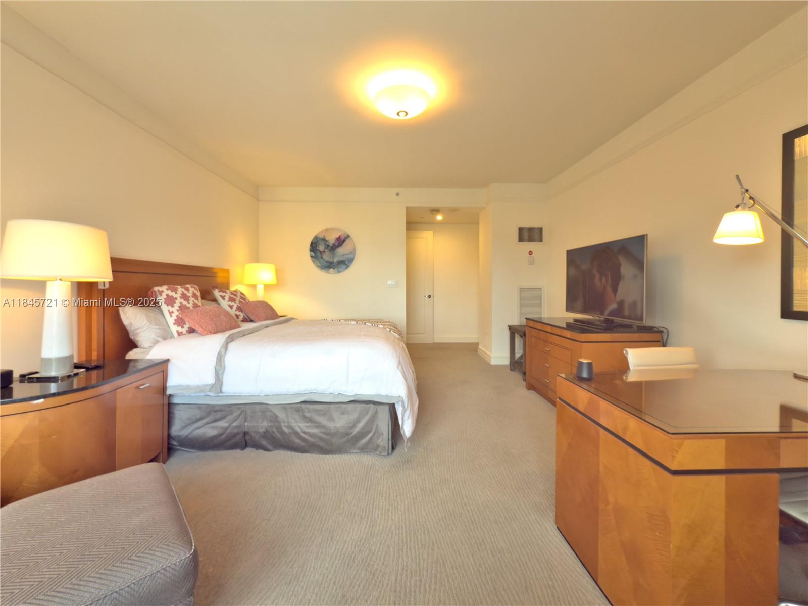 1435 Brickell Avenue, Unit 3412 Miami, FL 33131 - Photo 27 of 44 a bedroom with a bed and flat screen tv