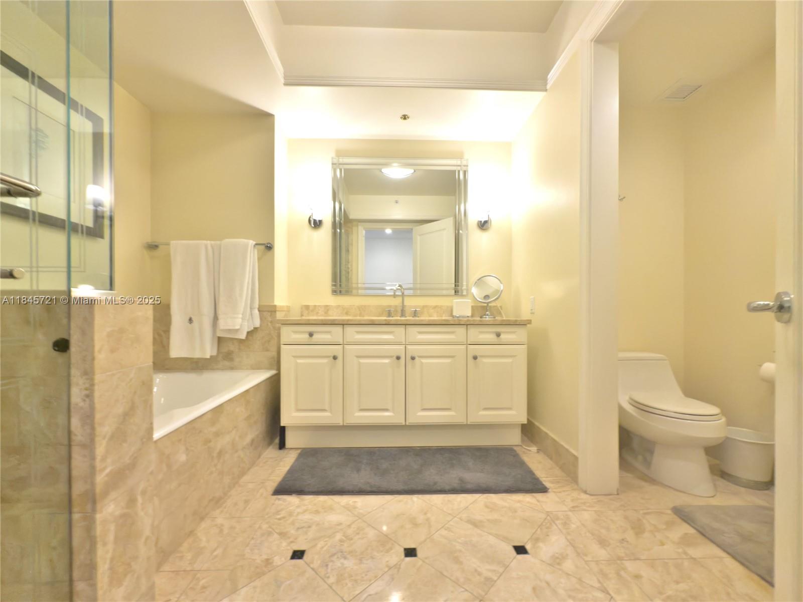 1435 Brickell Avenue, Unit 3412 Miami, FL 33131 - Photo 28 of 44 a bathroom with a sink a toilet and shower
