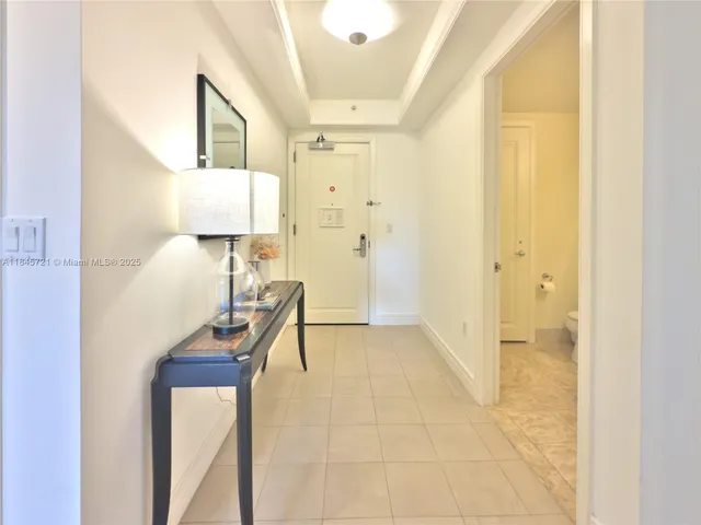 a view of hallway with furniture and a lamp
