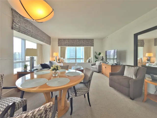 a living room with furniture a window and a table