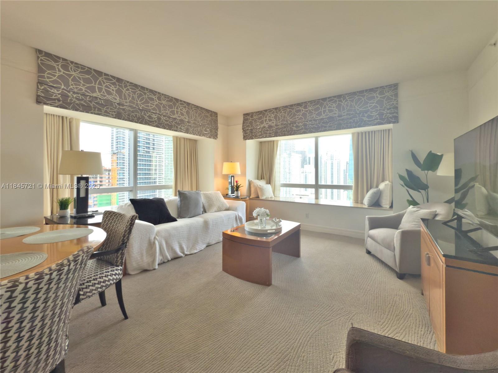 1435 Brickell Avenue, Unit 3412 Miami, FL 33131 - Photo 36 of 44 a living room with furniture and a large window