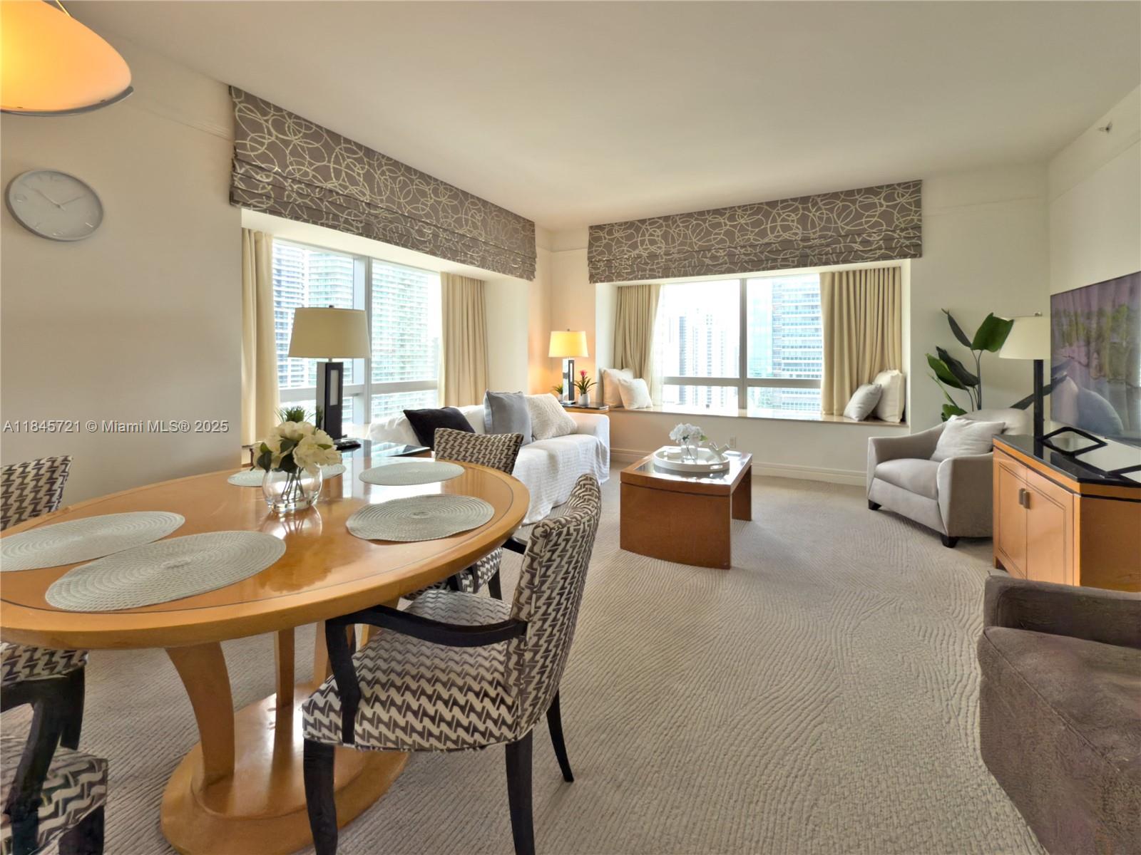 1435 Brickell Avenue, Unit 3412 Miami, FL 33131 - Photo 39 of 44 a view of a dining room with furniture and a large window