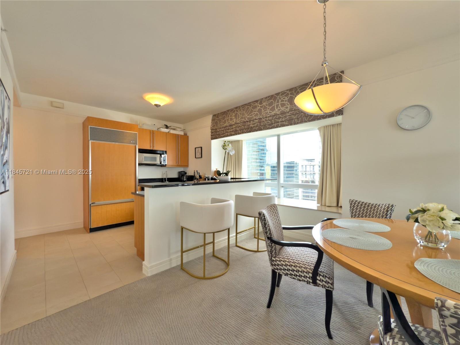 1435 Brickell Avenue, Unit 3412 Miami, FL 33131 - Photo 41 of 44 a kitchen with a table and chairs in it