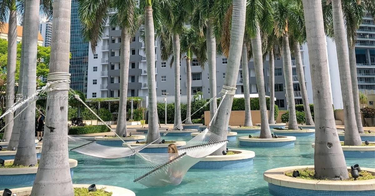 1435 Brickell Avenue, Unit 3412 Miami, FL 33131 - Photo 43 of 44 a view of a swimming pool with a sitting area