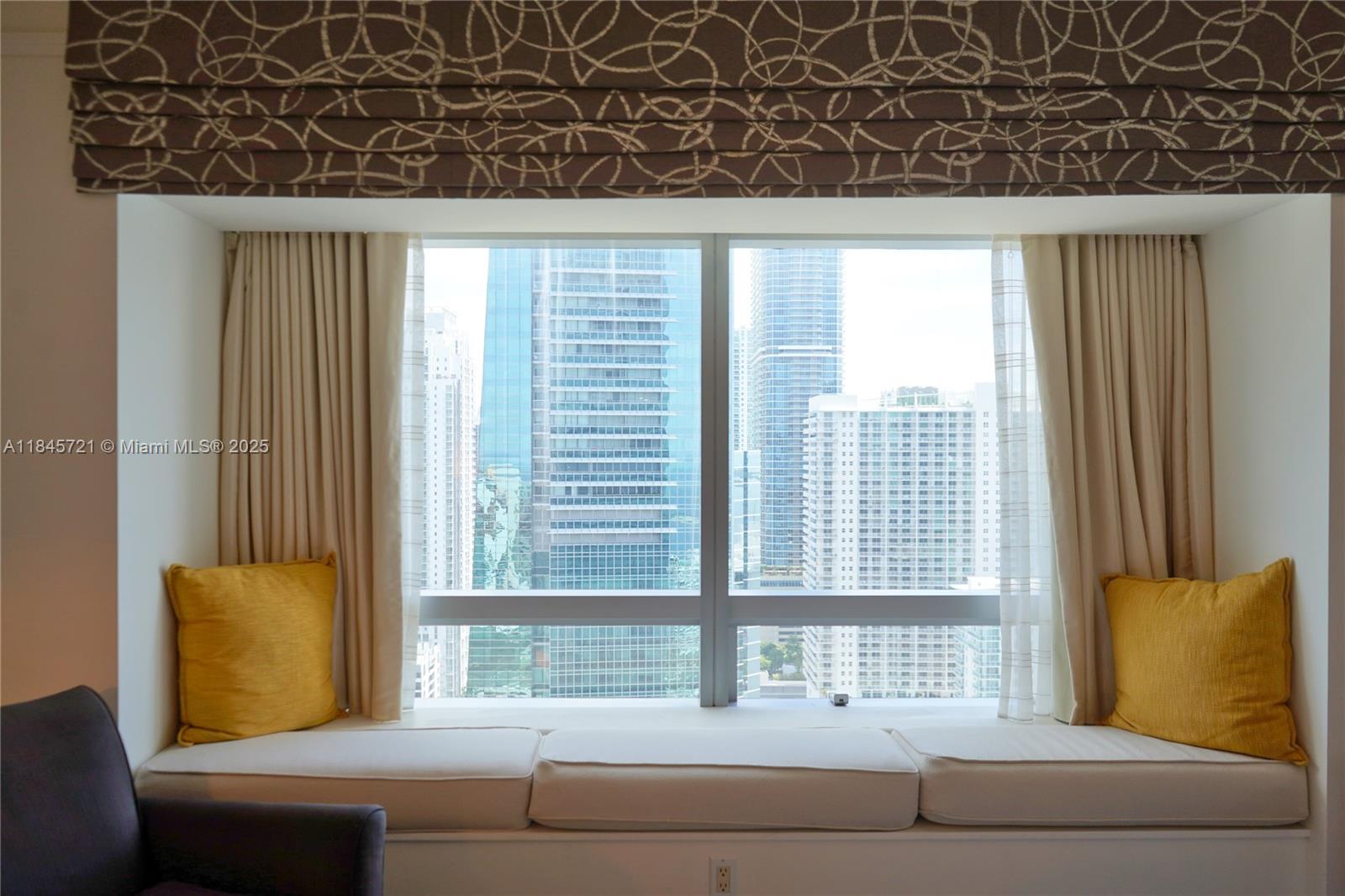 1435 Brickell Avenue, Unit 3412 Miami, FL 33131 - Photo 5 of 44 a living room with a couch and a window