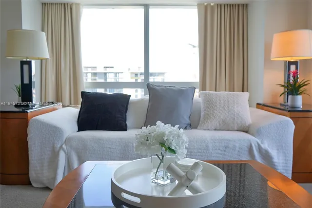 a living room with furniture and a lamp