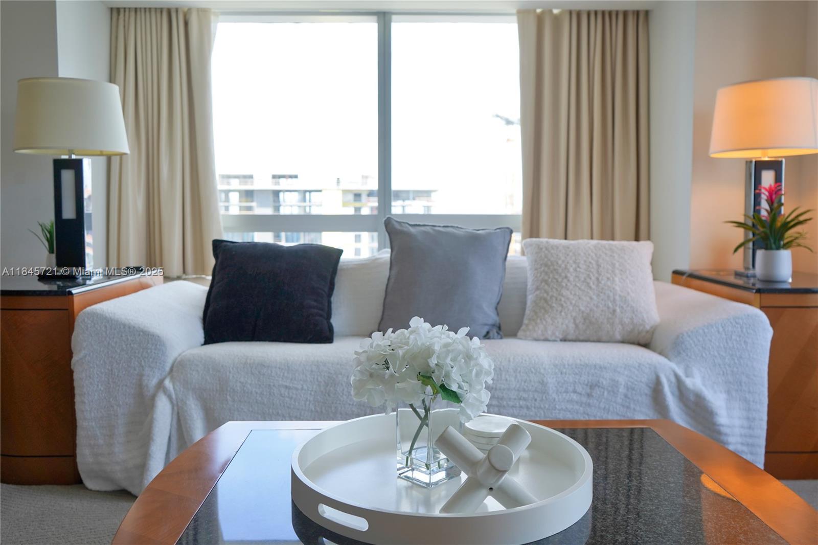 1435 Brickell Avenue, Unit 3412 Miami, FL 33131 - Photo 6 of 44 a living room with furniture and a lamp