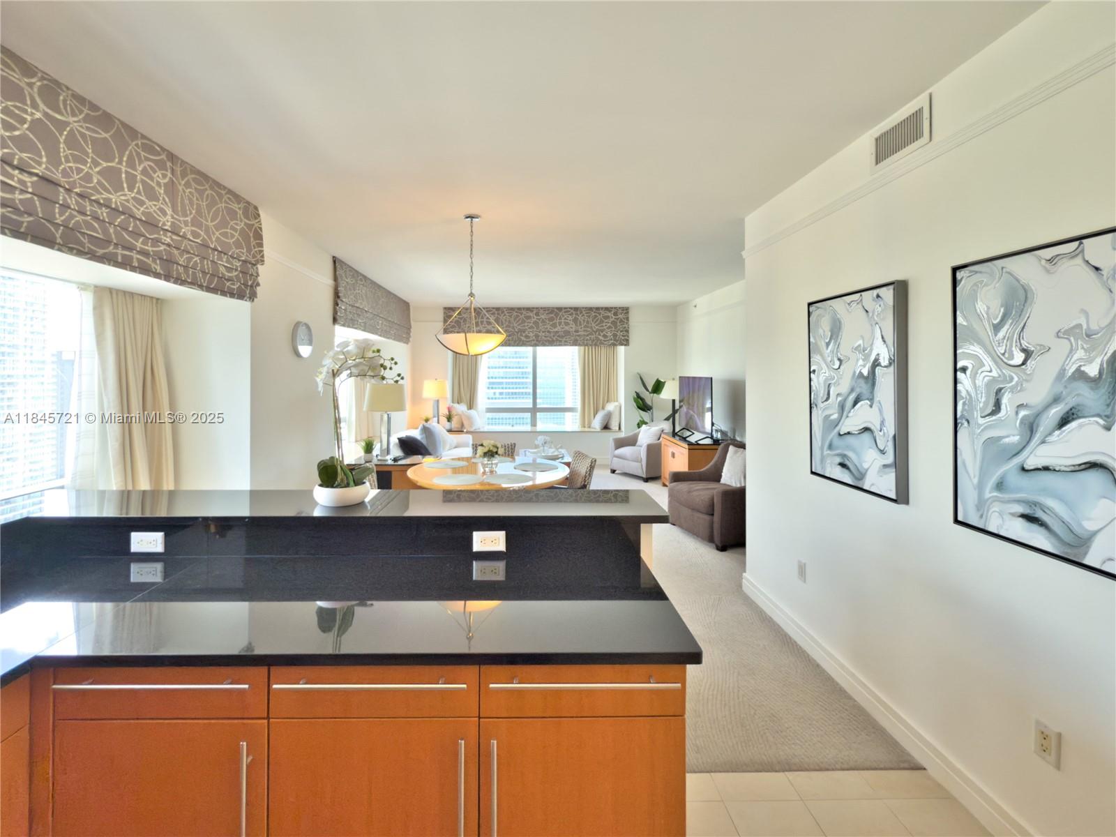1435 Brickell Avenue, Unit 3412 Miami, FL 33131 - Photo 8 of 44 a view of a kitchen with kitchen island a sink a counter top space and a window