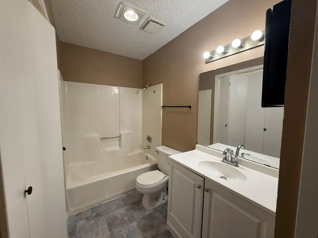 a bathroom with a sink toilet and mirror