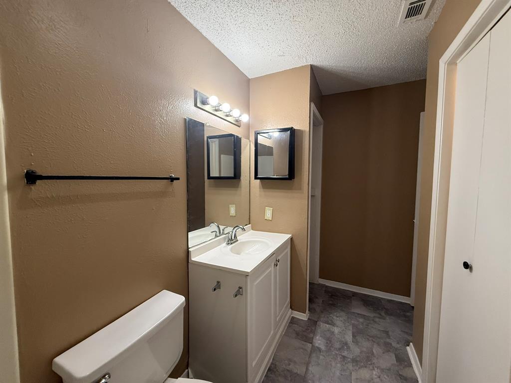 9696 Walnut Street, Unit 606 Dallas, TX 75243 - Photo 15 of 17 a bathroom with a sink toilet and mirror
