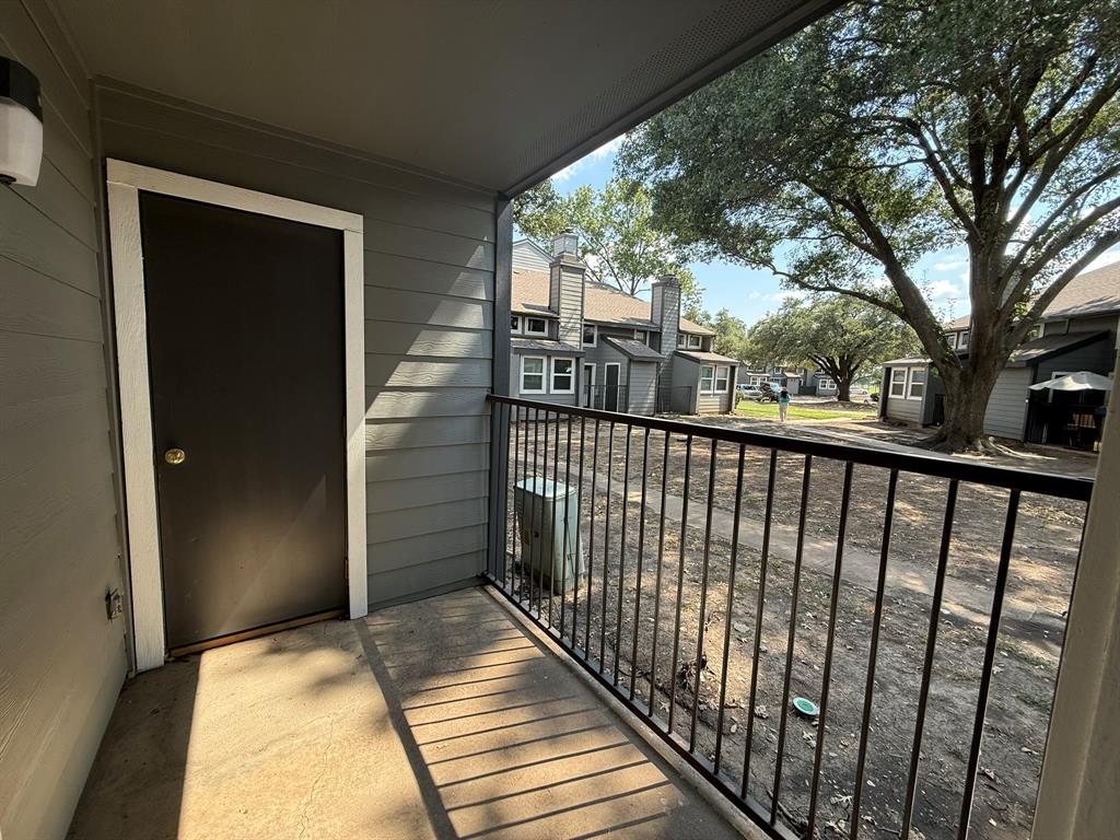 9696 Walnut Street, Unit 606 Dallas, TX 75243 - Photo 16 of 17 a view of a balcony with wooden floor
