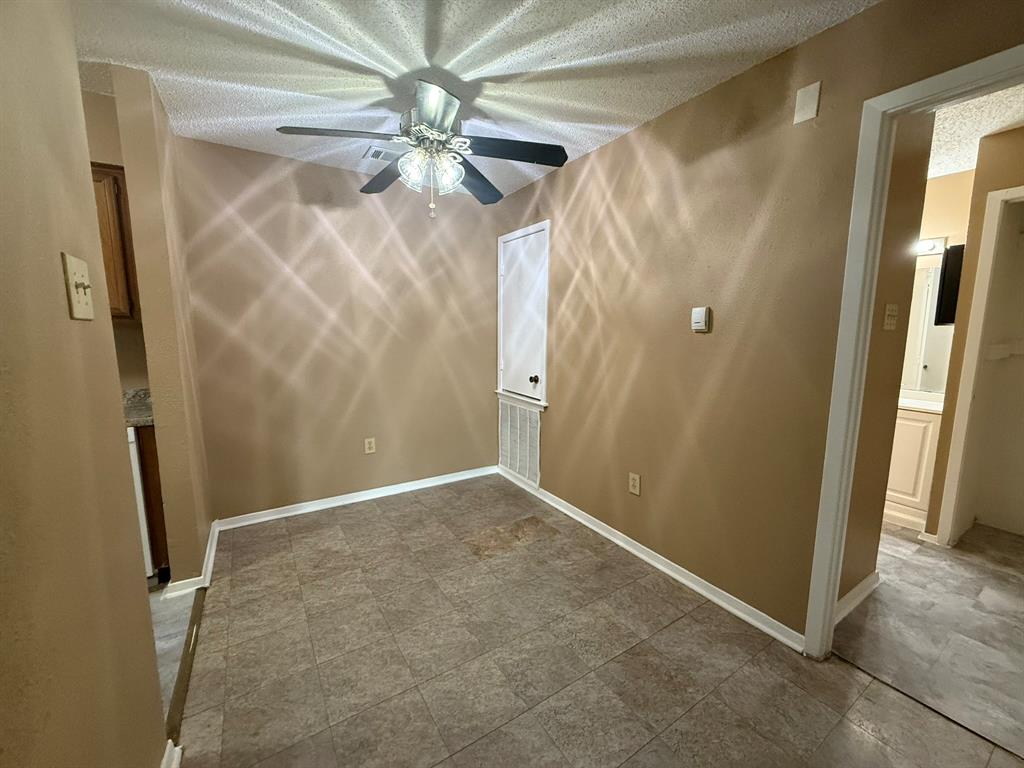 9696 Walnut Street, Unit 606 Dallas, TX 75243 - Photo 5 of 17 an empty room with windows and a fan