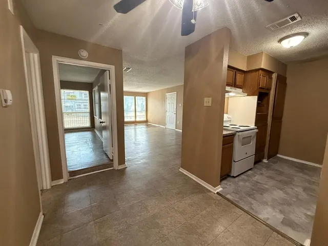 a kitchen that has a sink a stove and a refrigerator