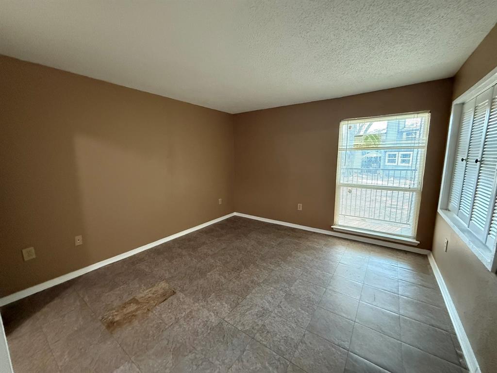 9696 Walnut Street, Unit 606 Dallas, TX 75243 - Photo 9 of 17 an empty room with wooden floor and windows