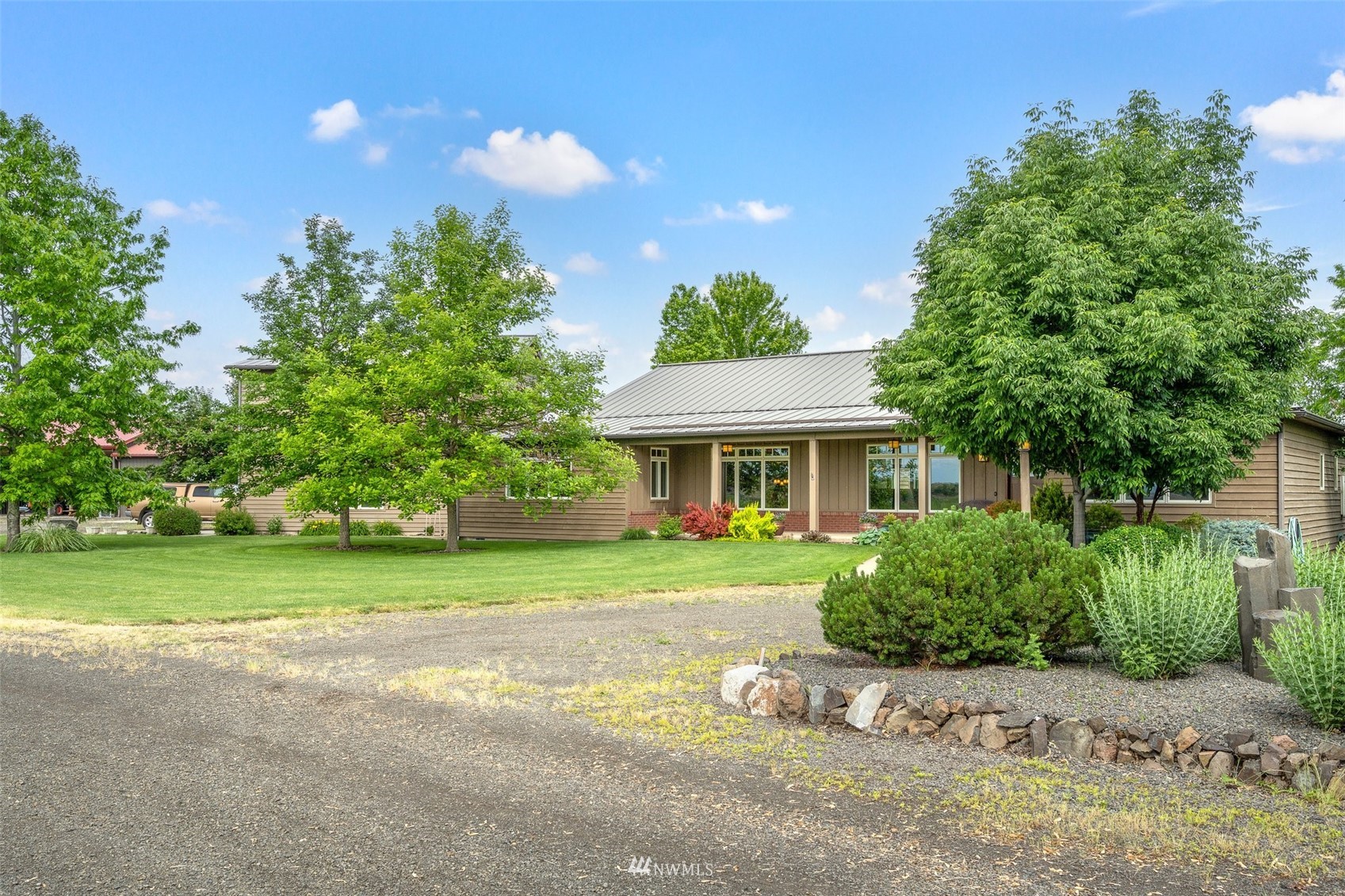 273 Galloway Road Touchet, WA 99360 - Photo 2 of 39 a front view of a house with a garden and porch