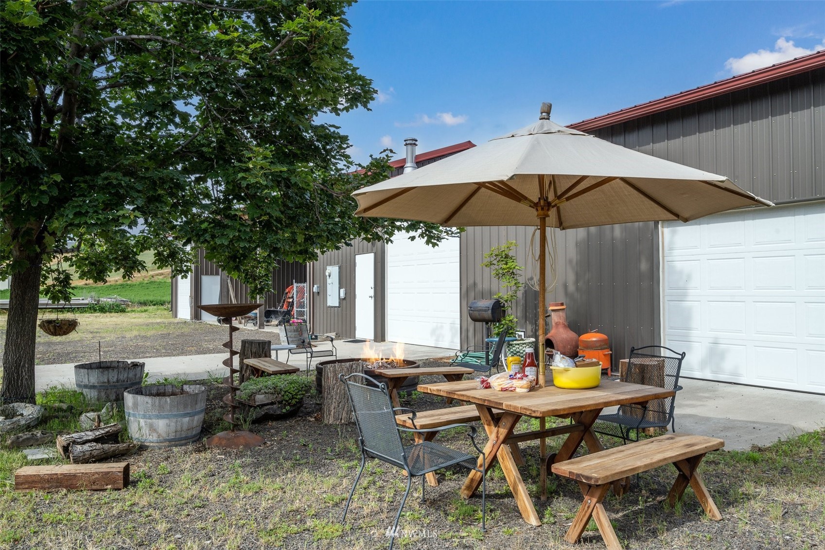 273 Galloway Road Touchet, WA 99360 - Photo 35 of 39 a view of a patio with couches table and chairs under an umbrella