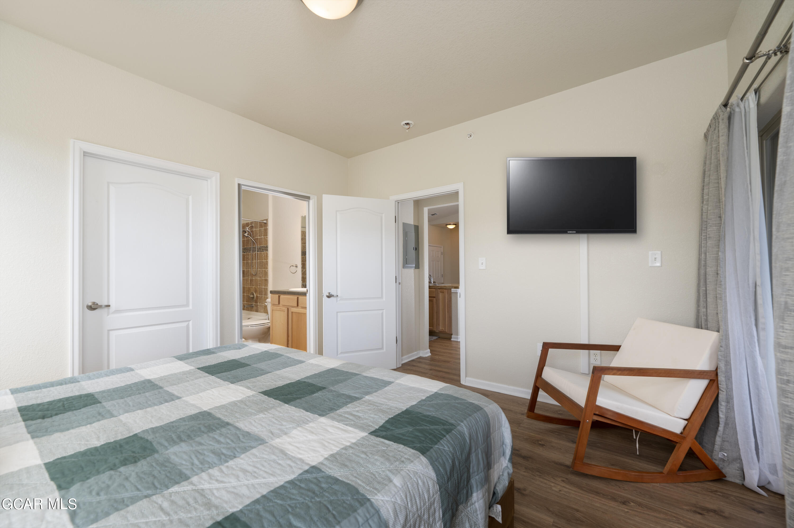 152 Village Road, Unit B306 Granby, CO 80446 - Photo 11 of 32 a bedroom with a bed a flat screen tv and a couch