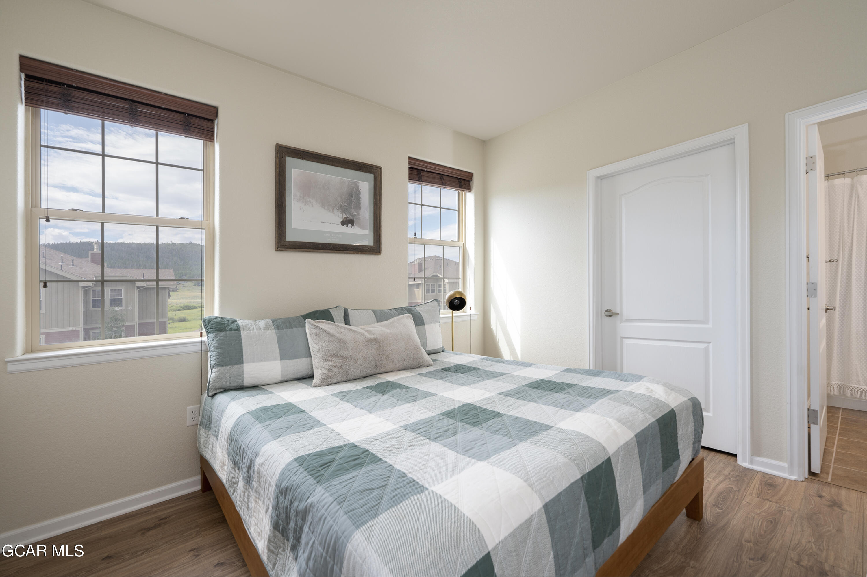 152 Village Road, Unit B306 Granby, CO 80446 - Photo 12 of 32 a bedroom with a bed and a window