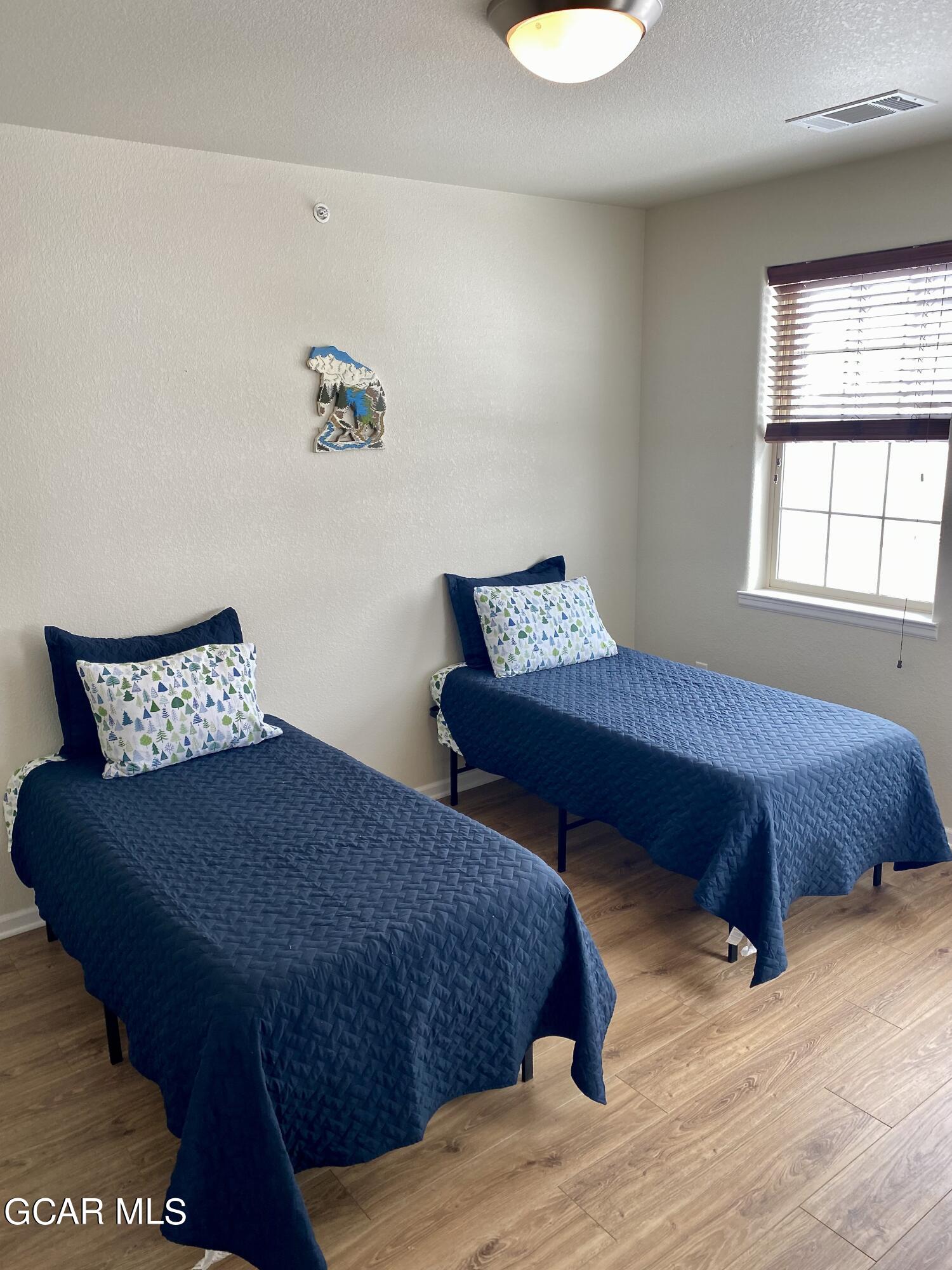 152 Village Road, Unit B306 Granby, CO 80446 - Photo 14 of 32 a bedroom with a bed and a window