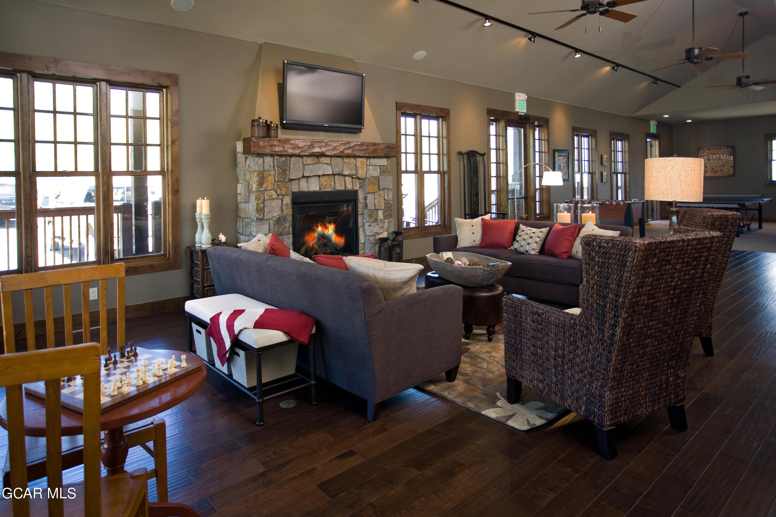 152 Village Road, Unit B306 Granby, CO 80446 - Photo 23 of 32 a living room with furniture a flat screen tv and a fireplace