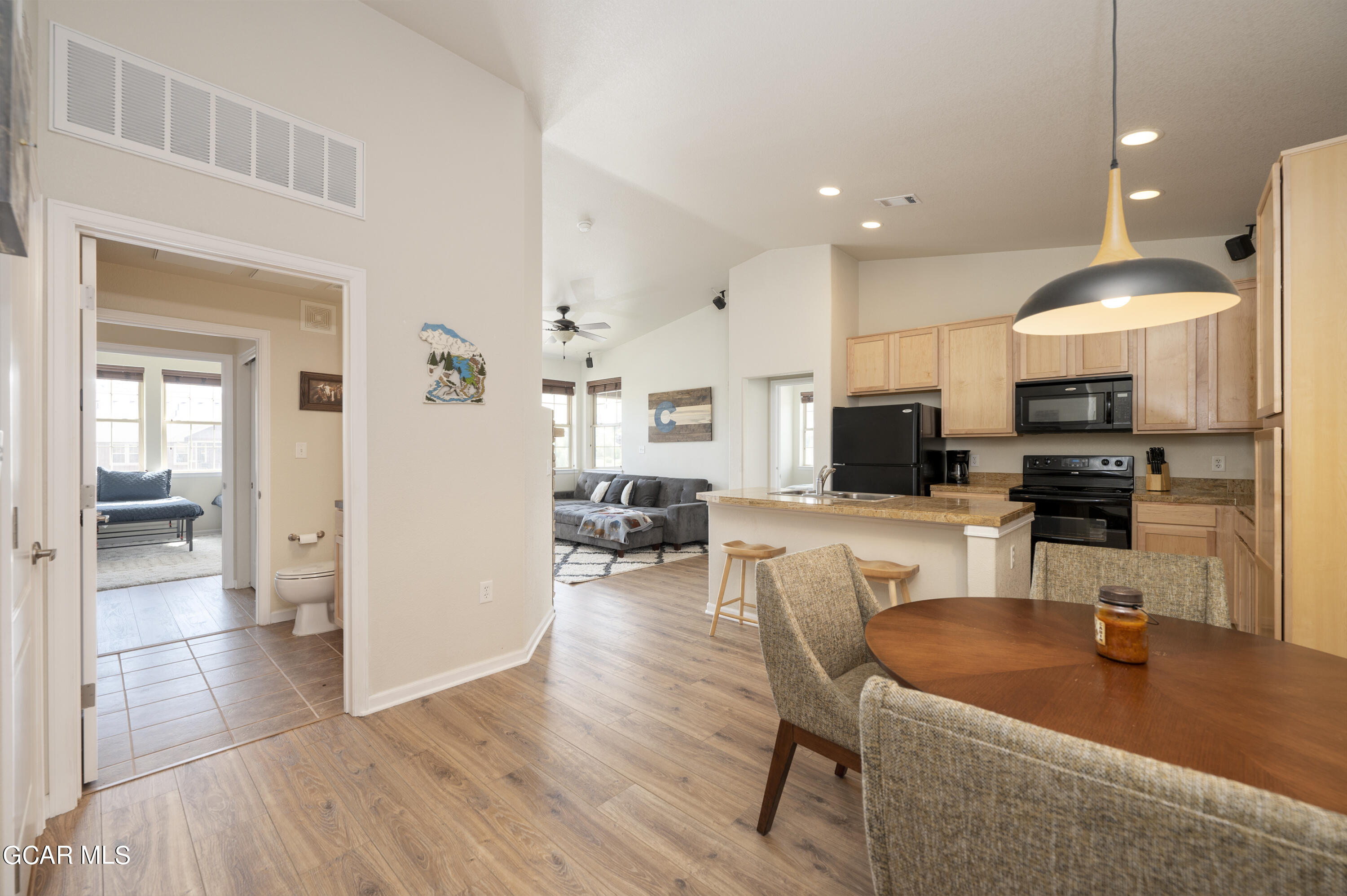 152 Village Road, Unit B306 Granby, CO 80446 - Photo 3 of 32 a living room with furniture a flat screen tv and kitchen view