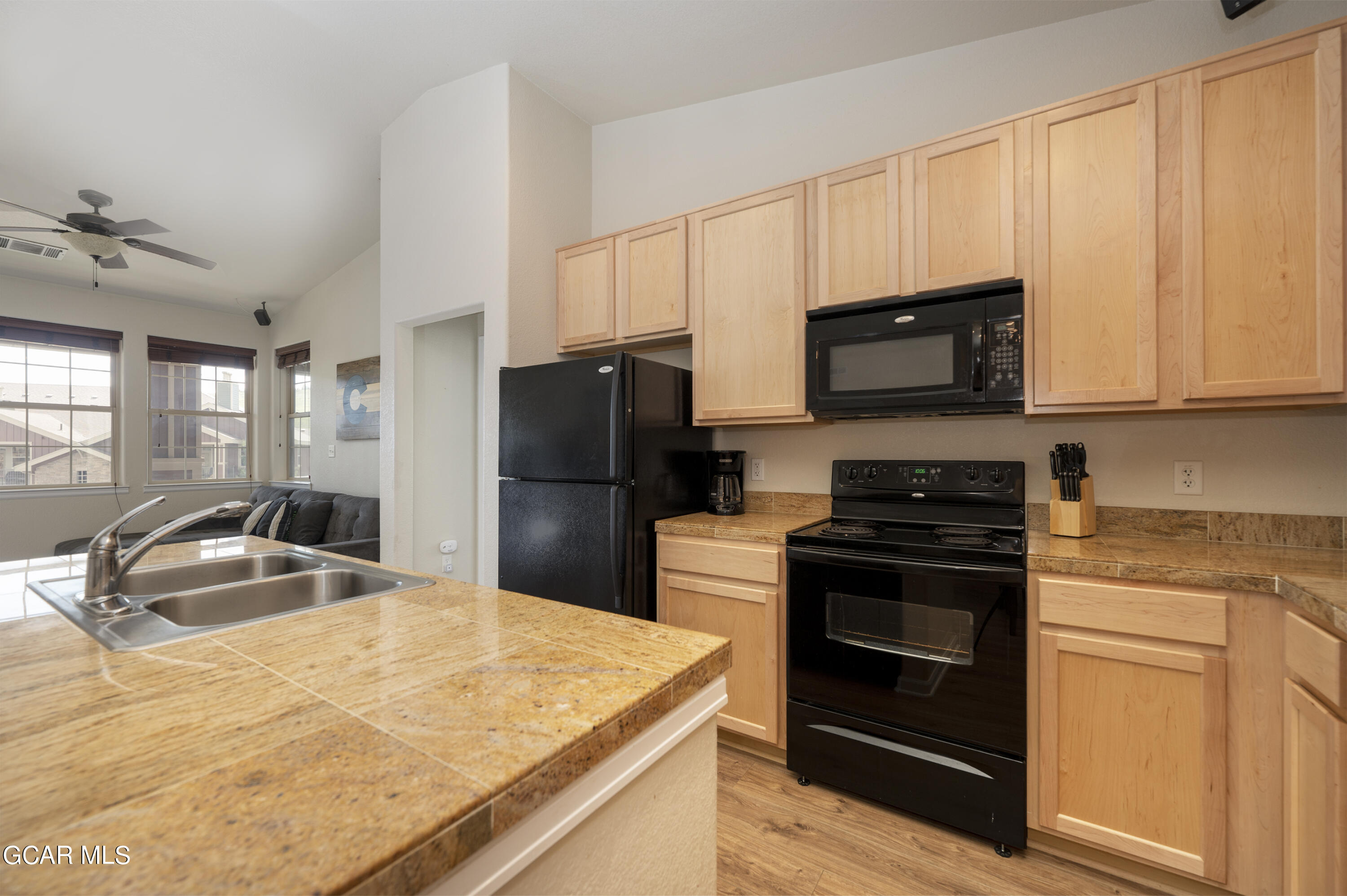 152 Village Road, Unit B306 Granby, CO 80446 - Photo 5 of 32 a kitchen with a sink stove and refrigerator