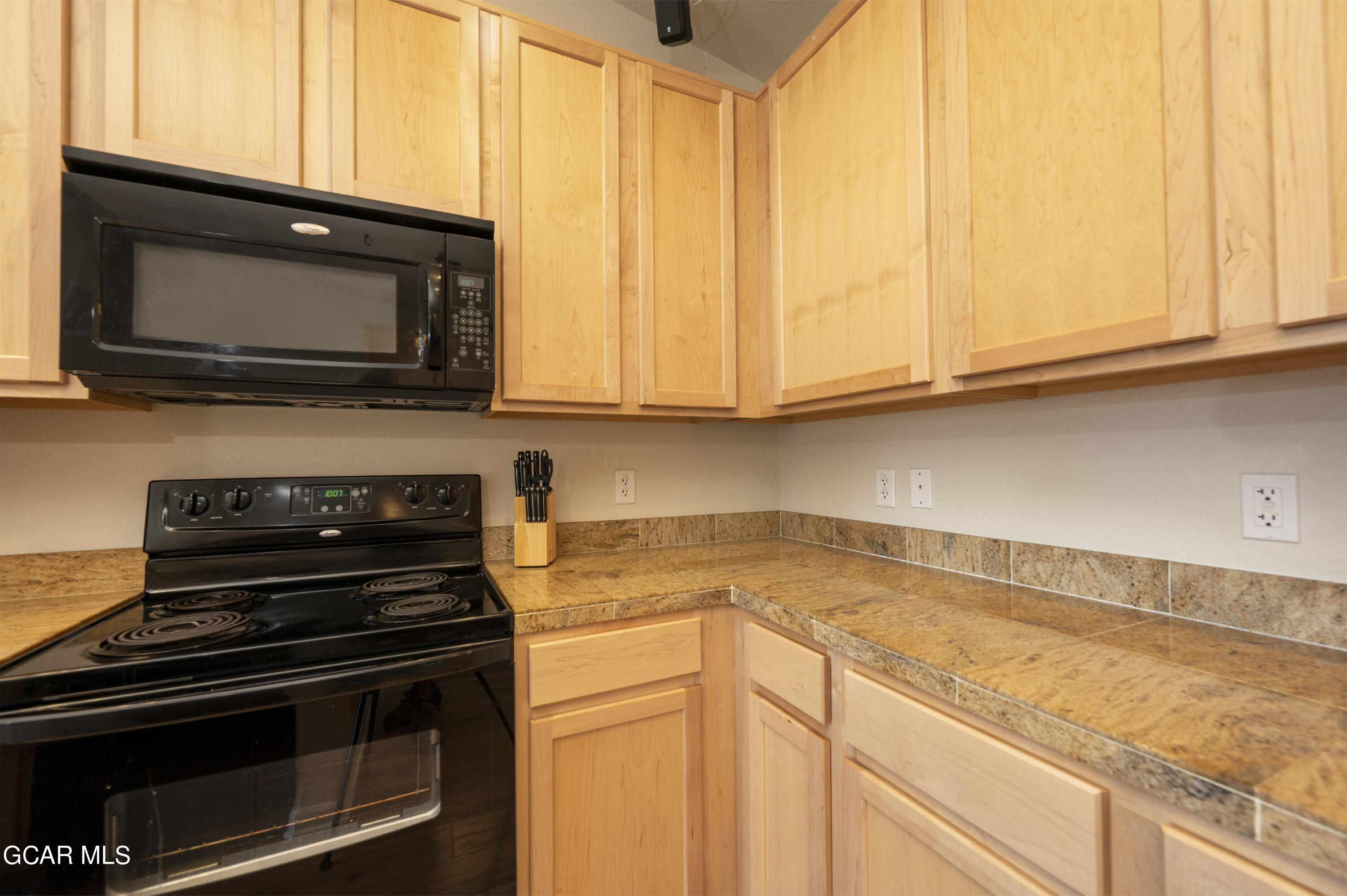 152 Village Road, Unit B306 Granby, CO 80446 - Photo 6 of 32 a kitchen with a stove and a microwave