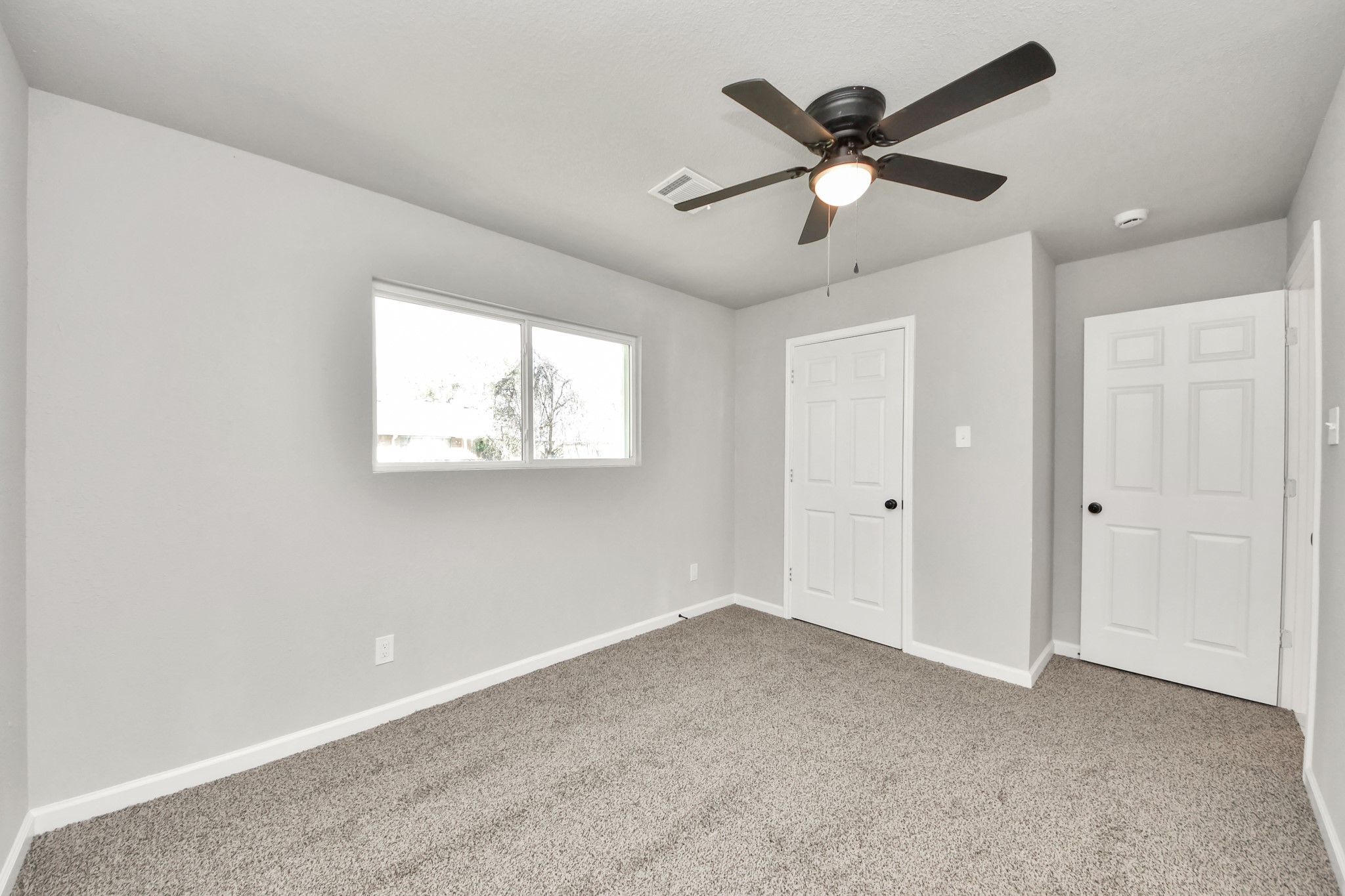15123 Kaler Road Houston, TX 77060 - Photo 12 of 24 a view of an empty room with a ceiling fan