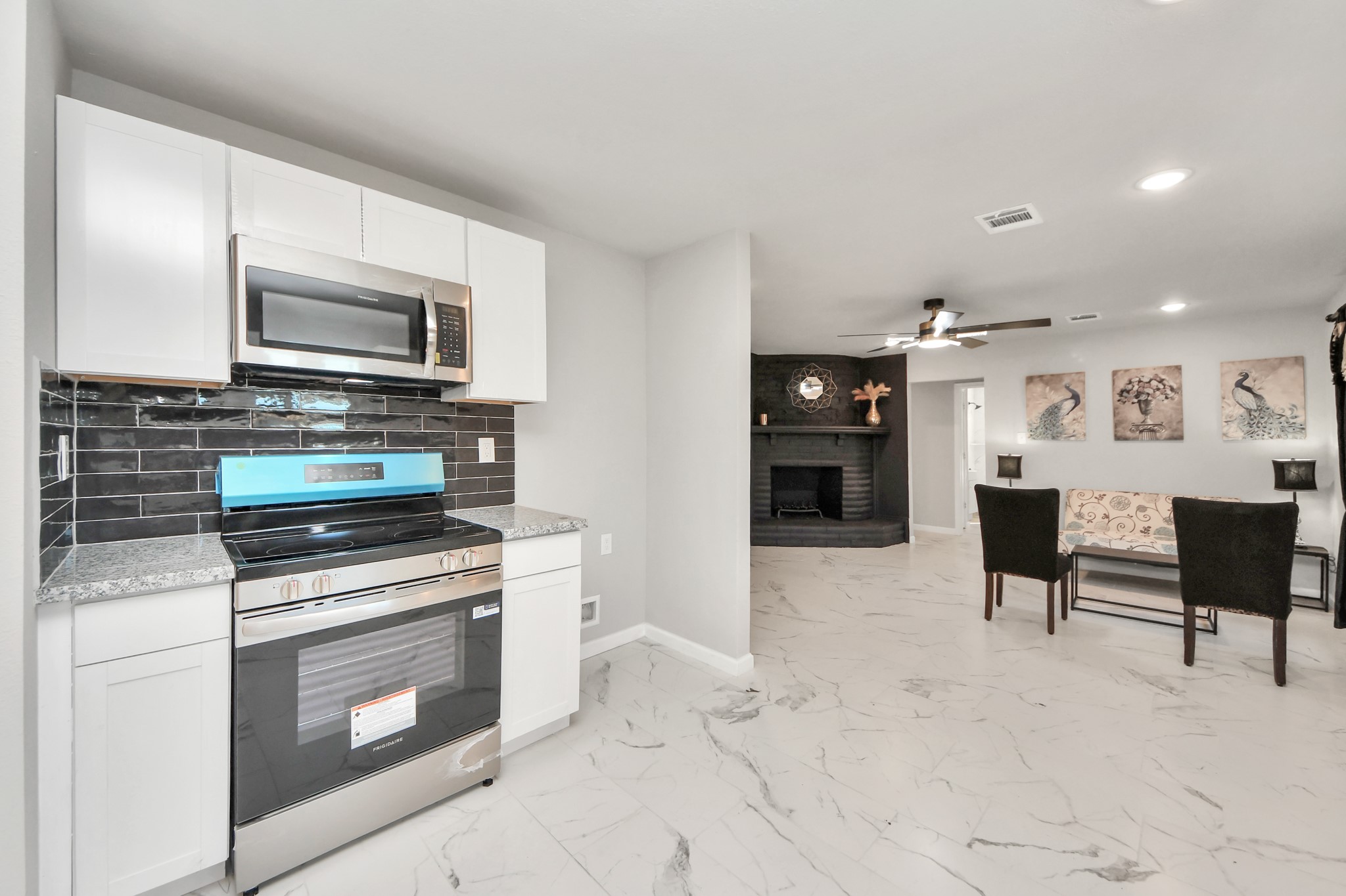 15123 Kaler Road Houston, TX 77060 - Photo 9 of 24 a kitchen with stainless steel appliances kitchen island granite countertop a stove and cabinets