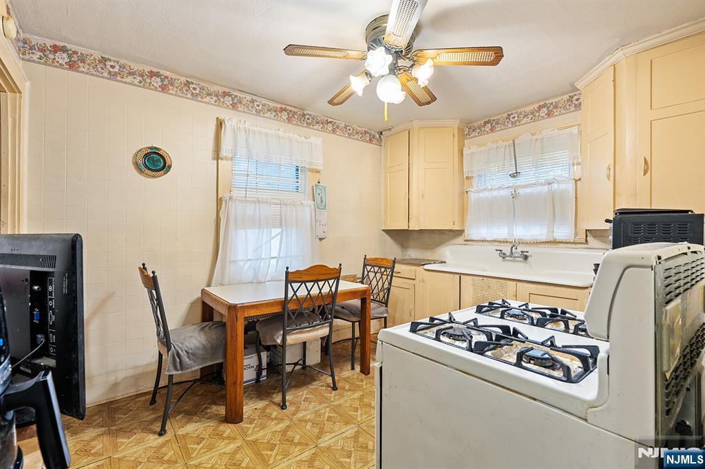 15 Victor Place Irvington, NJ 07111 - Photo 3 of 12 a kitchen with a dining table and chairs