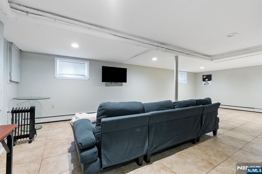 15 Victor Place Irvington, NJ 07111 - Photo 6 of 12 a living room with furniture and a flat screen tv