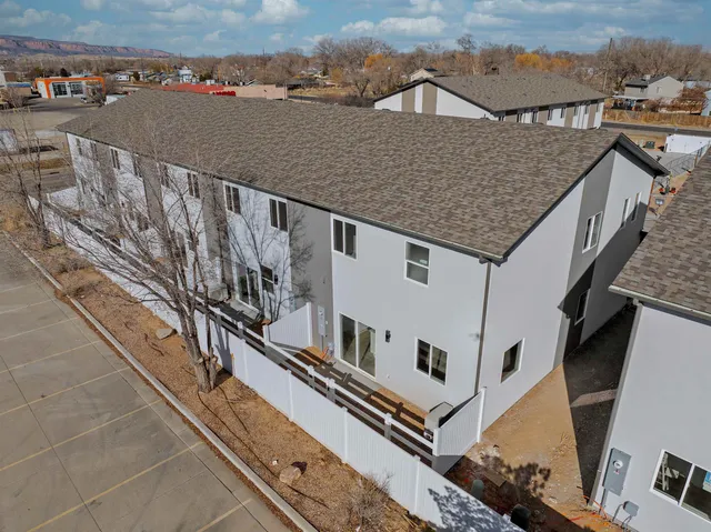 a view of kitchen with stainless steel appliances refrigerator stove dining table and chairs